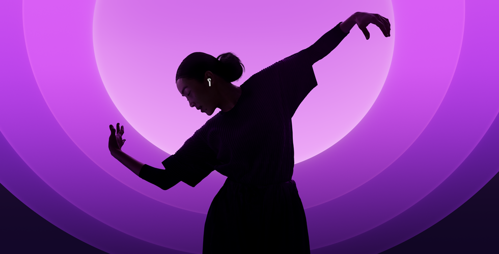A person dancing while wearing AirPods 5, multi-coloured background