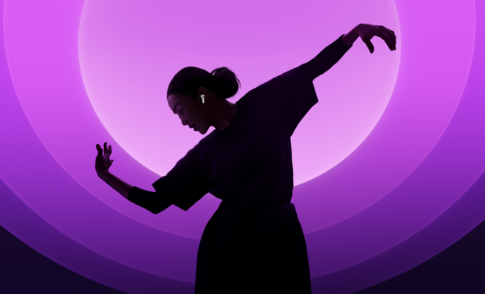 A person dancing while wearing AirPods 5, multi-coloured background