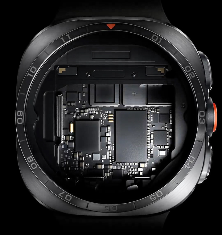 Close-up view of inside the case of a Galaxy Watch Ultra2 in Titanium Silver with a Marine Band in Olive. As it zooms in, the watch turns off and each part is lifted off one after another, showing the brilliant 5,000-nit display, the reliable 800 mAh battery and the powerful Snapdragon® Wear Elite Platform.