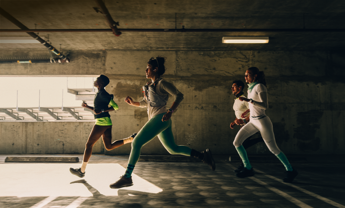 A group of people running in a city while wearing Apple Watch Series 12