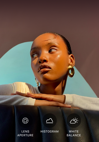 Close up portrait of a well-lit model with a colourful background, demonstrating the pro camera system's Pro controls UI: Aperture, Histogram, White Balance